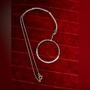 Silver necklace with oxidized pendant.